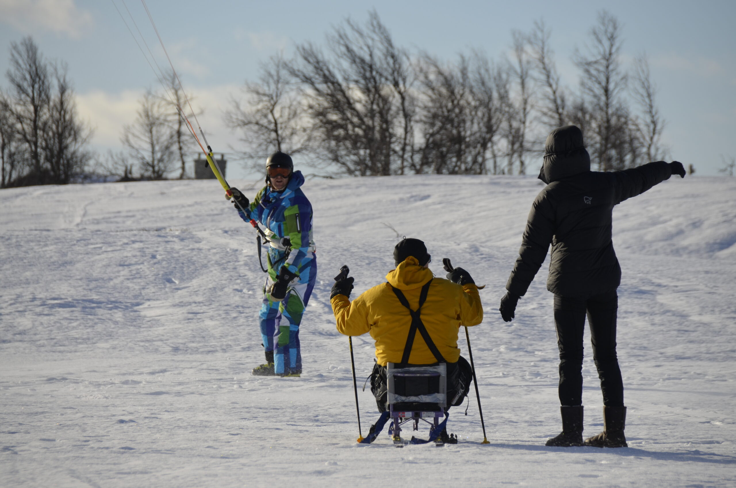 Kiting instructor with sit ski participant